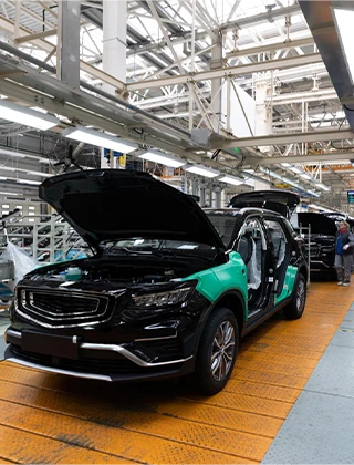 Automotive manufacturing assembly line utilizing Industrial IoT smart robotics and vehicle production tracking.