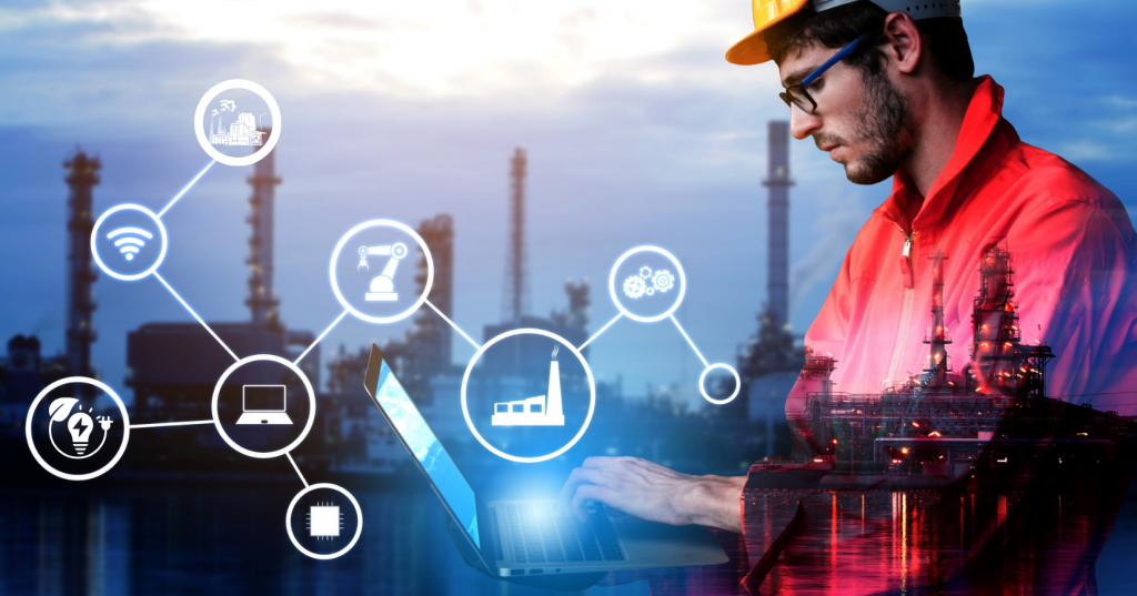 A factory plant manager tracking energy consumption and peak demand analytics through a smart IoT energy monitoring system on a laptop